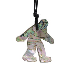 May include: A necklace with a pendant shaped like a person made of iridescent abalone shell. The pendant is attached to a black cord.