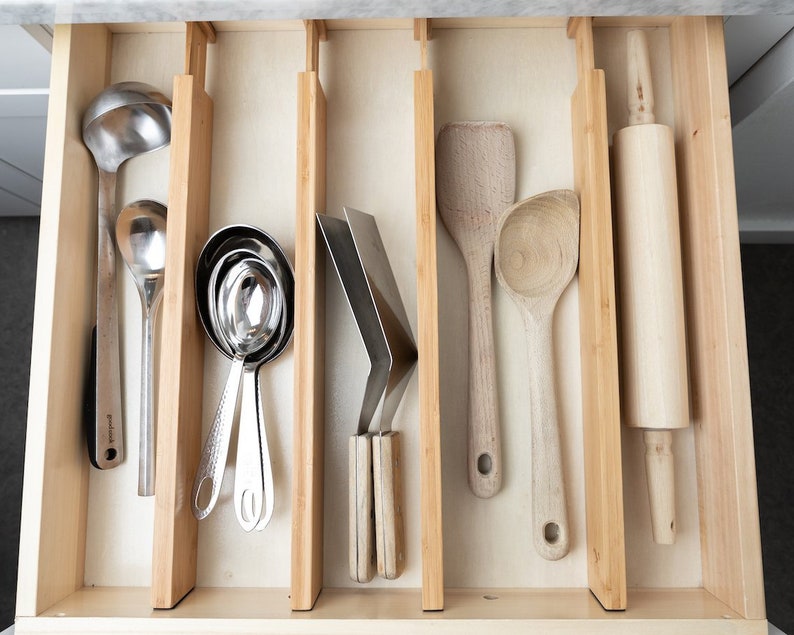 Kitchen organization products are what help make a kitchen more efficient. If you can't find what you need quickly, everything takes longer! Get a more efficient kitchen with these organization products you'll find on Etsy. These drawer dividers are a game changer! 