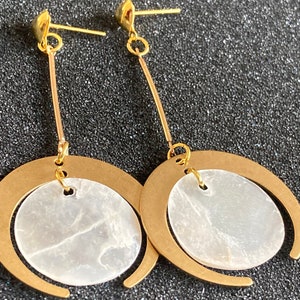 Philippine Capiz shell dangle drop brass gold heart earrings. Crescent moon pendant with round mirror shell gold stud earrings.