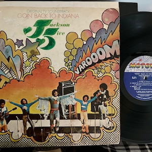 May include: A vinyl record album cover with a colorful, psychedelic design featuring the text "Goin' Back to Indiana" and "Jackson 5". The album cover is from the Motown record label.