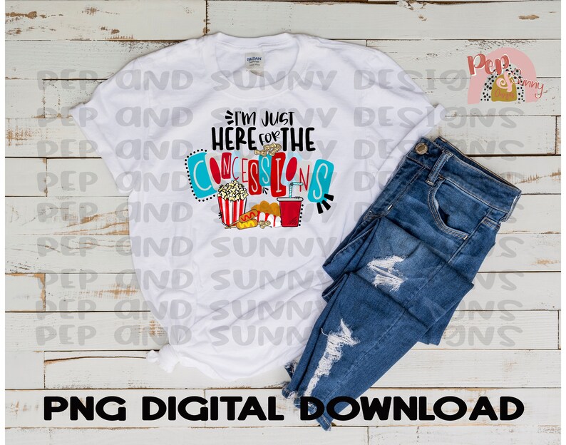 May include: White t-shirt with a colorful graphic that says "I'm just here for the concessions". The graphic includes a popcorn bucket, hot dog, and a drink.