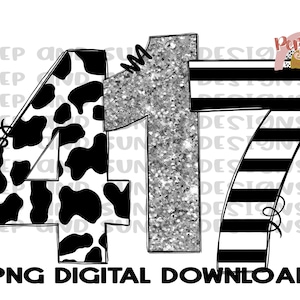 May include: A digital download of a graphic design featuring the numbers 4 and 7. The number 4 is black and white with a cow print pattern. The number 7 is black and white with horizontal stripes. The number 1 is silver glitter.