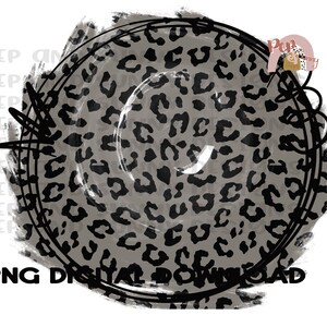 May include: A gray and black leopard print circle with a black outline and a white background. The circle is surrounded by black scribbles.