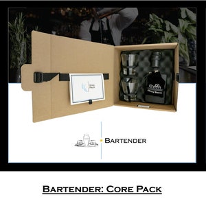 May include: Three brown cardboard boxes with the word "BARTENDER" printed on the side. Each box contains a different set of bar tools and a bottle of liquor. The boxes are labeled "Go-Pack", "Core Pack", and "Plus+ Pack".
