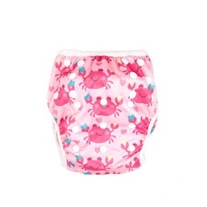 May include: Pink reusable swim diaper with a white trim and a pattern of pink crabs, hearts, and stars.