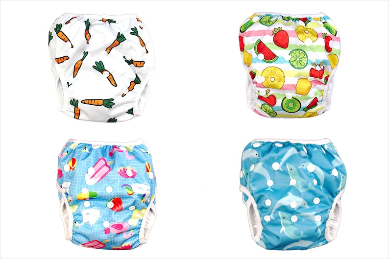 May include: Four different styles of reusable swim diapers for babies and toddlers. The diapers feature various colorful prints, including carrots, fruit, ice cream, and dolphins.