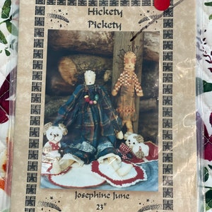 May include: A pattern for a 23-inch rag doll named Josephine June. The pattern includes instructions for a 12-inch wood doll. The pattern is titled "Hickety Pickety" and features a whimsical illustration of the doll.