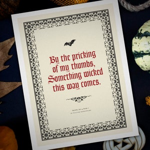 May include: A printable quote from Shakespeare's Macbeth, "By the pricking of my thumbs, Something wicked this way comes." The quote is printed in red on a cream background with a black decorative border.