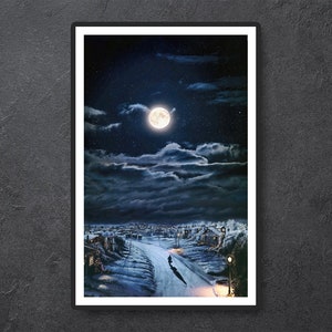 May include: A framed print depicting a nighttime winter scene. A full moon illuminates a snow-covered road winding through a small town. Dark clouds and a starry sky create a dramatic backdrop. A person walks down the road, casting a long shadow.