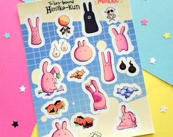 May include: A sheet of stickers featuring characters from the anime "Toilet-Bound Hanako-kun". The stickers are on a blue background with a grid pattern. The characters are pink and white, and there are also some black and white stickers. The text "Toilet-Bound Hanako-kun" and "Mokke" are printed on the sheet.