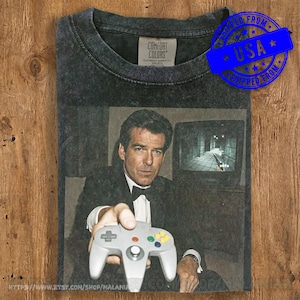 Camiseta GoldenEye de Pierce Brosnan para N64 - Camiseta estilo vintage de James Bond 007 - Camiseta retro de Nintendo 64 - Camiseta gráfica con colores cómodos