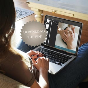 May include: A person using a laptop displaying a video of a facial massage. The screen shows a woman receiving a spa treatment. The laptop is open, and the text "DOWNLOAD THE PDF" is visible on the screen.