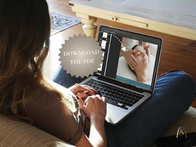 May include: A person using a laptop displaying a video of a facial massage. The screen shows a woman receiving a spa treatment. The laptop is open, and the text "DOWNLOAD THE PDF" is visible on the screen.