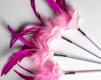 May include: Three cat teaser wands featuring vibrant magenta and soft light pink feathers attached to thin, flexible silver-toned rods. Each wand has a black connector securing the fluffy, layered plumage to the metallic handle for movement.