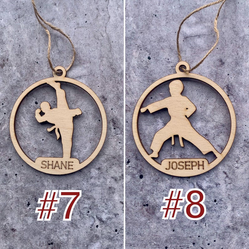 May include: Two wooden ornaments shaped like circles with a karate figure silhouette inside. The ornaments have a string for hanging and the names "Shane" and "Joseph" are written on the bottom. The ornaments are numbered "#7" and "#8".