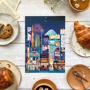 May include: A vibrant illustration of a Japanese cityscape at night, showcasing landmarks such as the Tokyo Tower and Mount Fuji, with fireworks. The image is surrounded by pastries, tea, and flowers, creating a warm, inviting atmosphere.