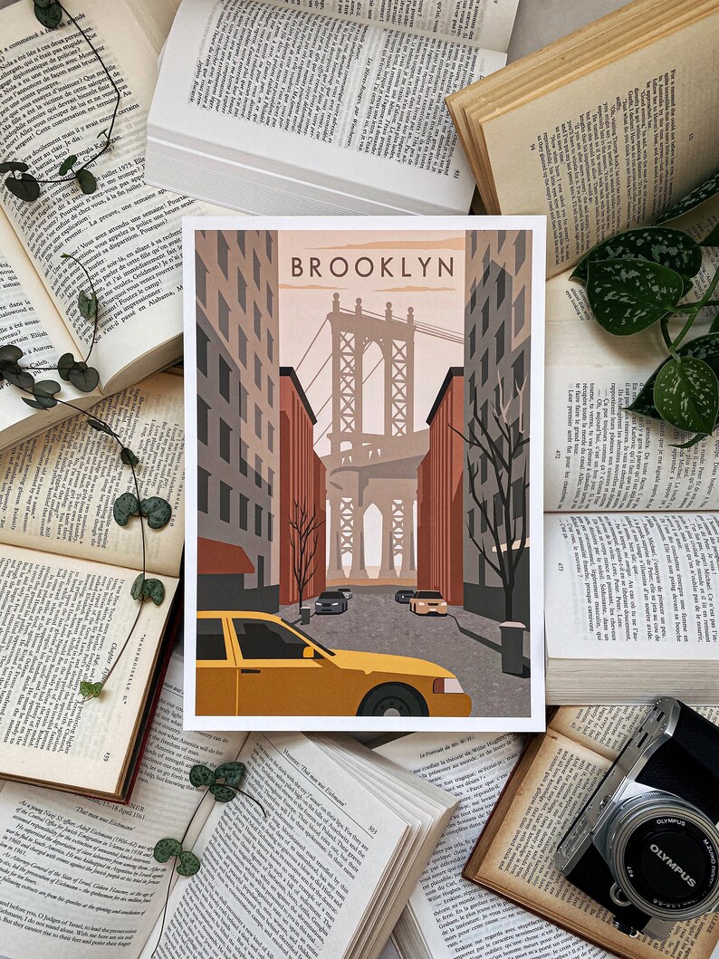 May include: A retro-style illustration of the Brooklyn Bridge in New York City. The image features a yellow taxi cab driving down a street with the bridge in the background. The text "BROOKLYN" is printed in bold letters at the top of the image.