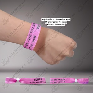 May include: A pink elastic wristband featuring the printed name SOPHIA and the text IF LOST PLEASE CALL, along with contact numbers for MOM and DAD. The wristband is adjustable and designed for emergency identification purposes.