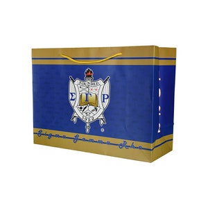 May include: A blue and gold gift bag with a Sigma Gamma Rho sorority crest. The crest features a shield with the letters "ΣΓΡ" and the words "Founded 1922".
