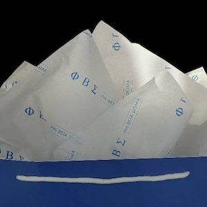 May include: A blue gift bag with white tissue paper inside. The tissue paper has the letters "ΦΒΣ" and "PHI BETA SIGMA" printed on it.