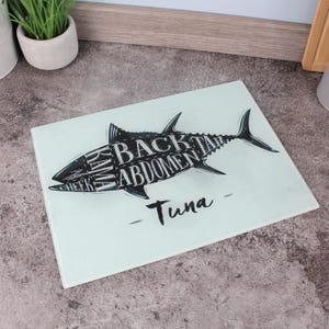 May include: A set of three ceramic mugs with a speckled, matte finish. The mugs are in cream, light grey, and dark grey. Each mug has a simple, minimalist design, ideal for coffee or tea.