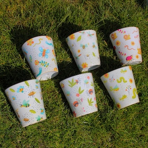 Puede incluir: Seis tazas blancas con diferentes diseños de insectos y naturaleza. Las tazas están hechas de bambú y son perfectas para el uso diario.