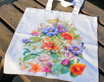 May include: White canvas tote bag with a floral print featuring a variety of colourful flowers, including red, orange, pink, purple, and blue.