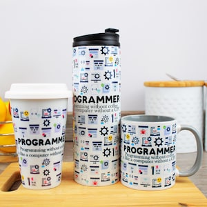 May include: Three white ceramic mugs with a black and white design featuring computer icons and the text "Programmer: Programming without coffee is like a computer without a CPU". The mugs are in different sizes, a travel mug, a mug with a handle, and a smaller mug.