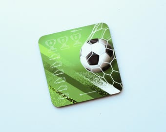 May include: A square coaster with a green gradient background featuring a black and white football hitting a white net. The design includes three white trophy icons at the top and a vertical column of six white football boot icons on the left.