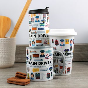 May include: Three mugs featuring a train driver theme. The mugs are white with a grey rim and handle. The mugs are decorated with colourful train and train-related icons. The text on the mugs reads "Train Driver I don't ride the crazy train - I drive it".