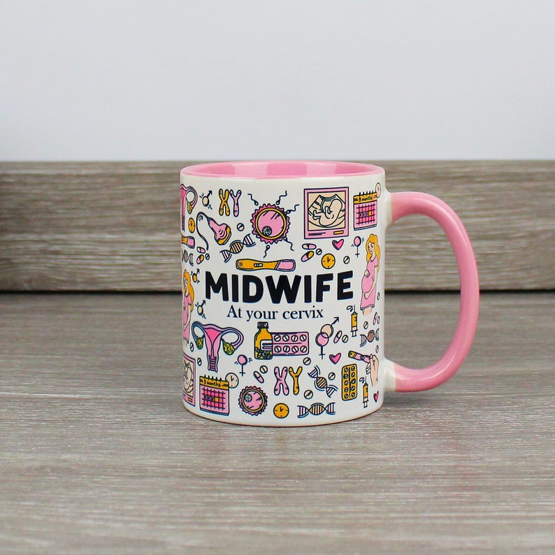 May include: A pink and white ceramic mug with a pink handle. The mug has a design of various medical illustrations related to pregnancy and childbirth. The text "MIDWIFE At your cervix" is printed on the mug.