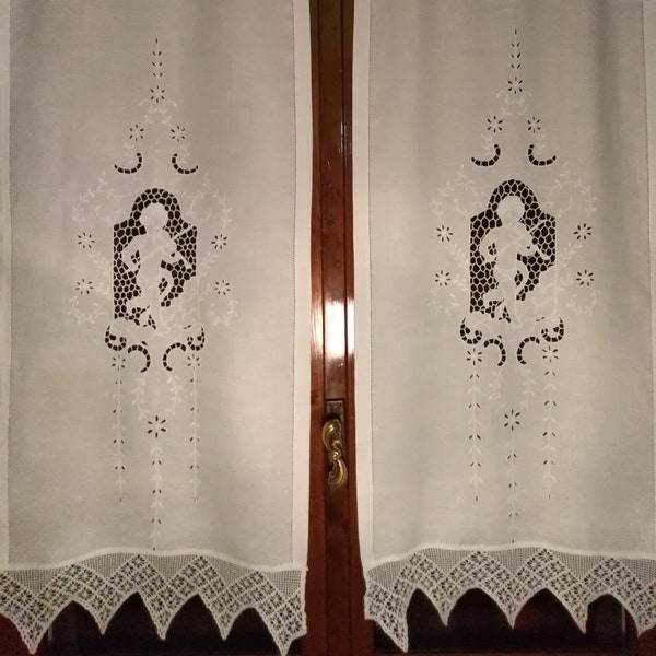 pair of hand embroidered curtains and crochet border.