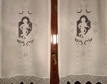 pair of hand embroidered curtains and crochet border.