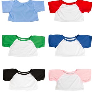six different t-shirt designs, each with a unique color and pattern, arranged in a grid-like pattern.