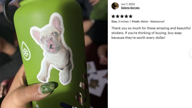A person's hand holding a green water bottle with a sticker of a dog on it. The person is also wearing green nail polish.