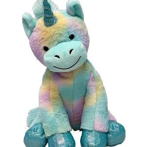 A plush toy of a unicorn with a blue and pink color scheme and a glittery horn.