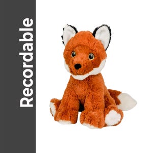 May include: A plush fox toy with orange fur, white accents on the chest, paws, and tail tip, and black-tipped ears. The fox has large, expressive eyes and is sitting upright. The word "Recordable" is printed vertically on a dark gray background.