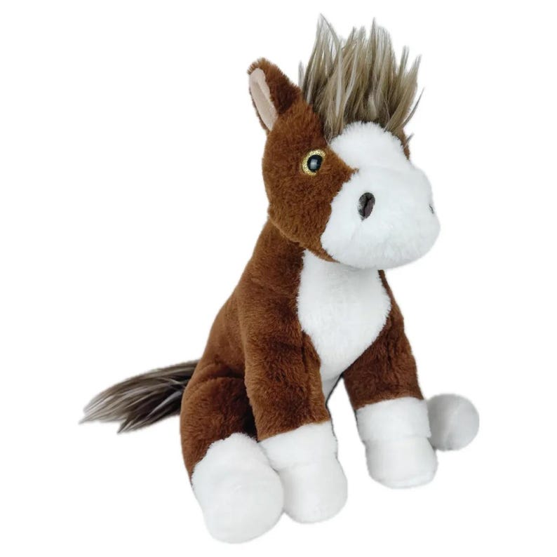 May include: A brown and white plush horse toy with a spiky mane and tail. The horse is sitting with its legs tucked under its body.