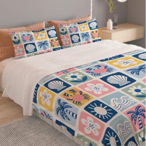 May include: A bedding set featuring a quilt and two pillowcases with a grid pattern of colorful squares. Each square displays a coastal or floral icon, including crabs, seashells, palm trees, suns, waves, and flowers in shades of blue, pink, and yellow.