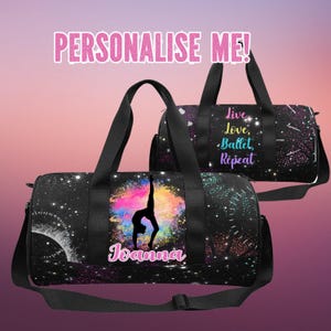 May include: Black duffel bag with a galaxy print and a colourful watercolour splash design. The bag features a silhouette of a gymnast in a backbend pose. The text "Joanna" is printed in pink below the gymnast. The bag has a black strap and a zipper closure. The text "Live, Love, Ballet, Repeat" is printed on a second bag in the background.
