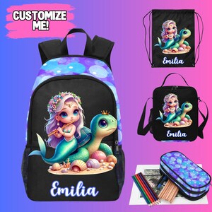 May include: A black backpack, drawstring bag, lunch bag, and pencil case set. Each item features a mermaid and turtle design with the name "Emilia". The backpack has a purple and blue pattern, and the text "Customize Me!"