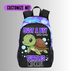 May include: Black backpack with a cartoon turtle design. The backpack features the text "JUST A BOY who loves TURTLES MICHAEL" and "CUSTOMIZE ME!". The turtle is green with a brown shell, set against a blue and purple bubble pattern.