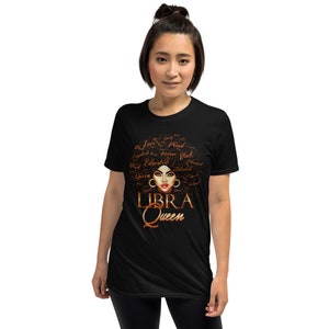 May include: Black t-shirt featuring a brown and gold graphic of a woman's face with the words "LIBRA QUEEN" underneath. The graphic includes words such as "Love", "Queen", "Educated", "Talented", and "Strong" surrounding the woman's face.
