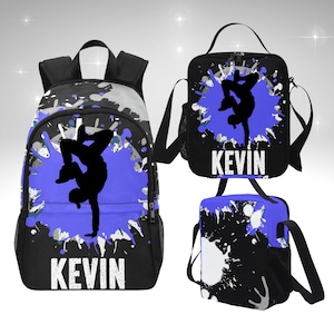 May include: A black backpack, lunch bag, and small bag set. Each item features a black silhouette of a breakdancer on a blue splatter design, with the name "KEVIN" in white block letters. The bags have black straps and accents.