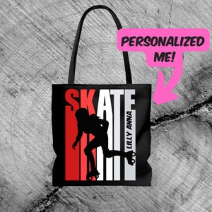 May include: Black tote bag with a white "SKATE" graphic and a silhouette of a roller skater. The graphic has red and white stripes. The text "Lilly Anna" is printed vertically on the right side of the bag.