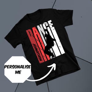 May include: Black t-shirt with a white silhouette of a dancer in a red and white striped background. The word "DANCE" is written vertically in white letters and the name "JOHNATHON" is written vertically in red letters.