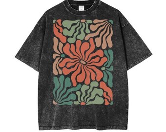 May include: Black t-shirt with a vintage-style floral print in shades of green, orange, and red. The shirt has a distressed look.