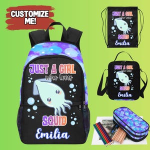 May include: A black backpack, drawstring bag, and lunch bag set featuring a squid design. The set includes a pencil case and coloured pencils. The text reads "JUST A GIRL who loves SQUID Emilia". The backpack has a purple and blue bubble pattern.