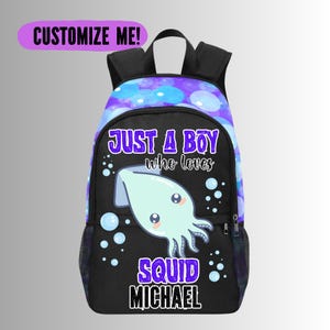 May include: Black backpack with a cartoon squid design and the text "JUST A BOY who loves SQUID MICHAEL". The top of the backpack has a purple and blue bubble pattern, and the words "CUSTOMIZE ME!" are at the top.