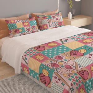 May include: A bedding set featuring a patchwork pattern of baseball-themed illustrations including pink gloves, yellow baseballs, bats, and home plates. The design incorporates teal star patterns, checkered squares, and striped sections in pink and tan.